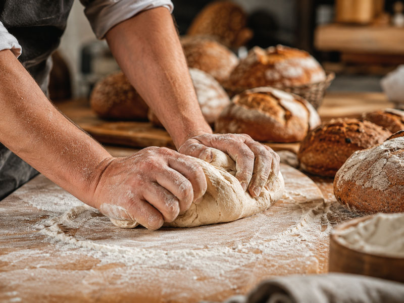 baker kneading dough